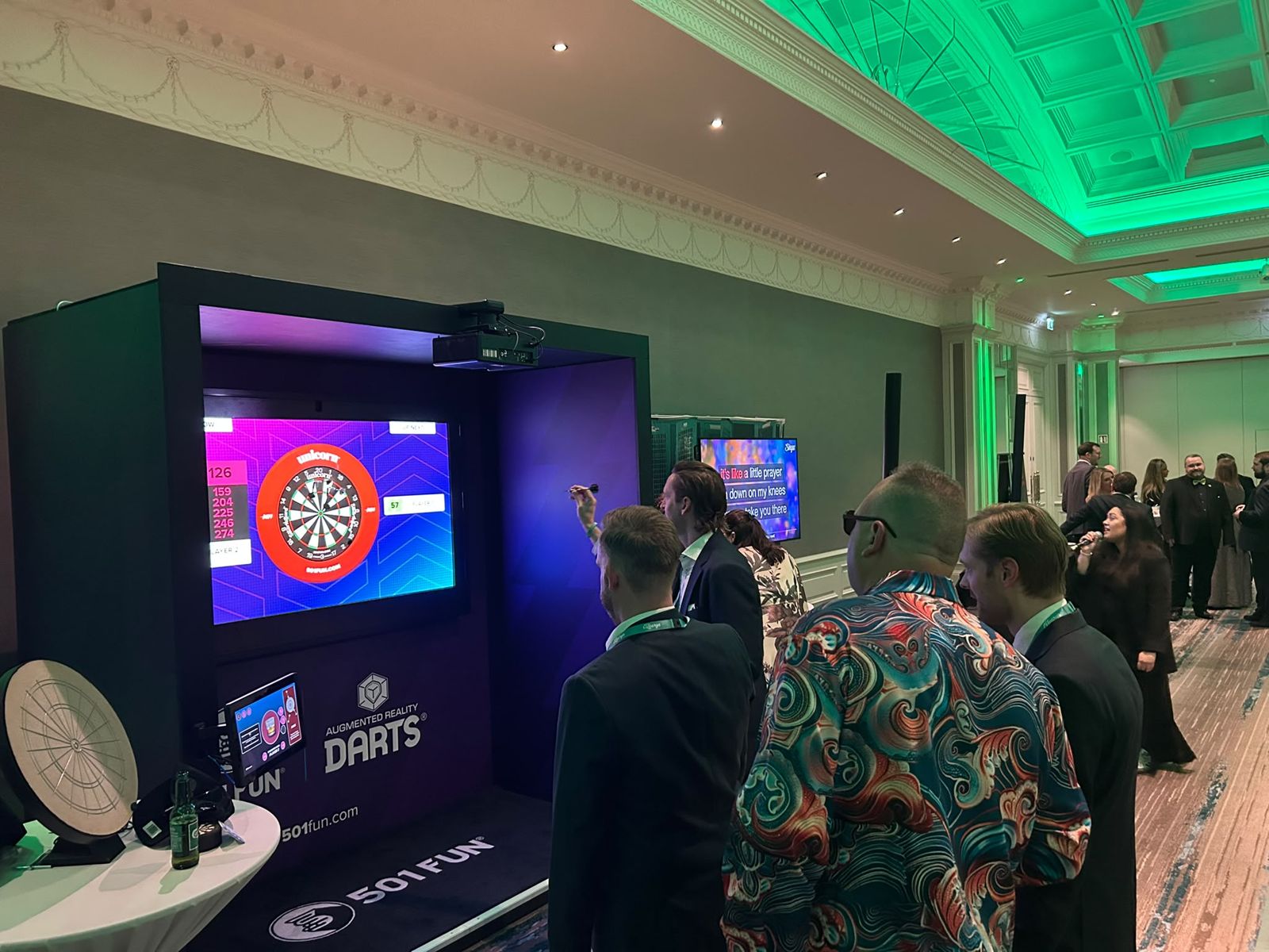 Guests playing a dart pod at an evening event