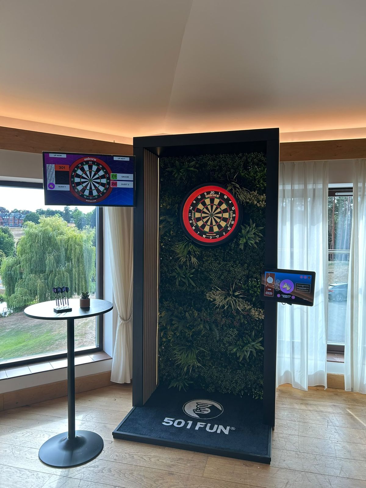 Dart pod set up in a venue with garden views